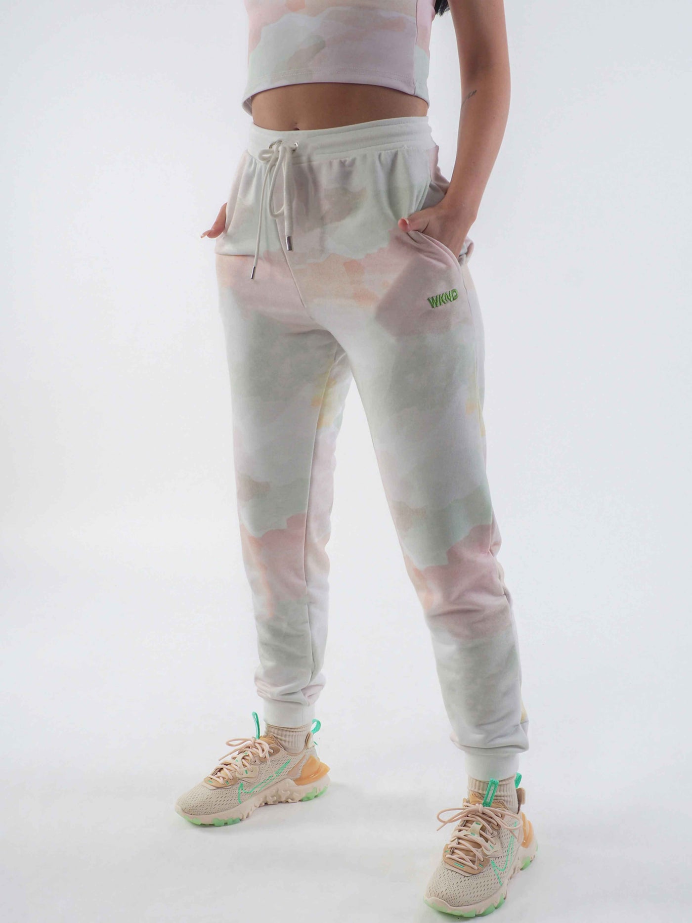 Model wearing joggers in a watercolour tie dye print