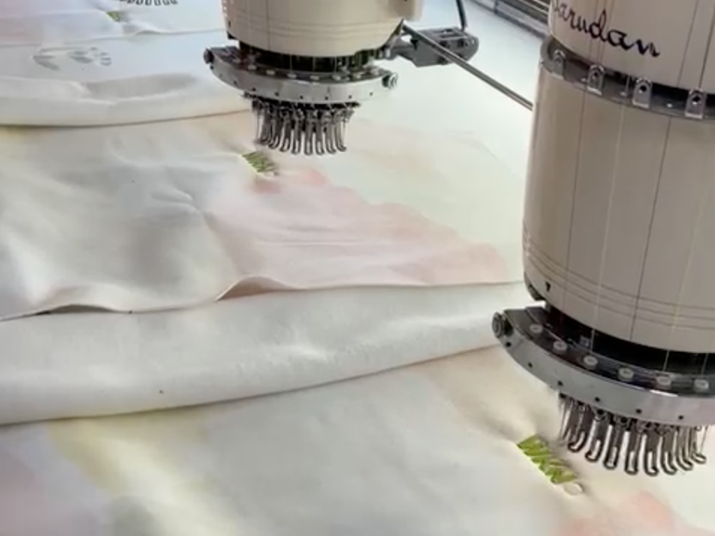 wknd embroidery taking place on watercolour tie dye fabric at the factory in Antalya, turkey. 