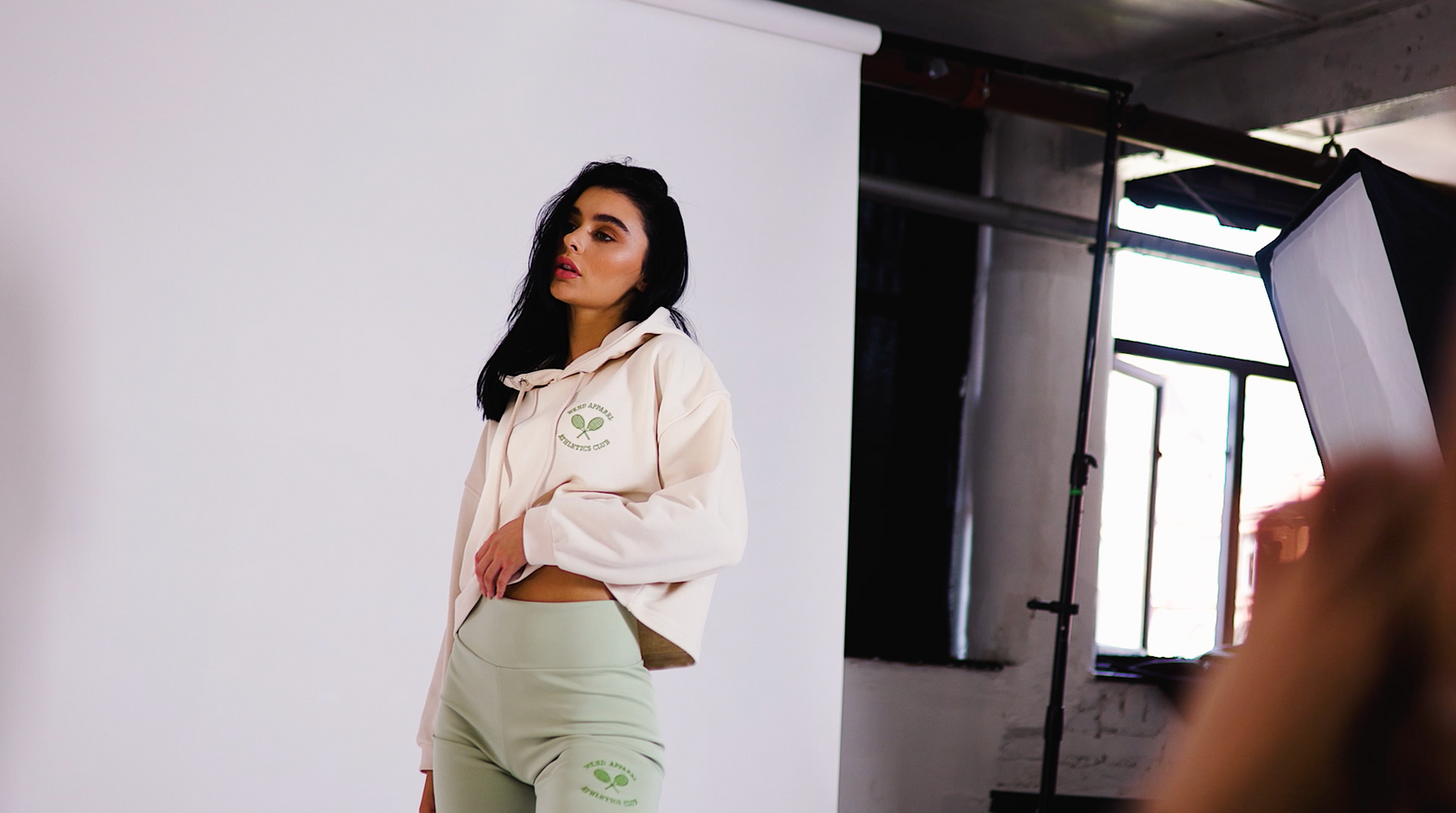 behind the scenes at the ss21 shoot in manchester. model is wearing a hoodie in eggnog and cycling shorts in jade green