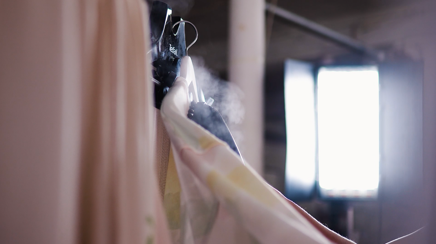hanging and steaming clothes to remove creases before being shot on a model