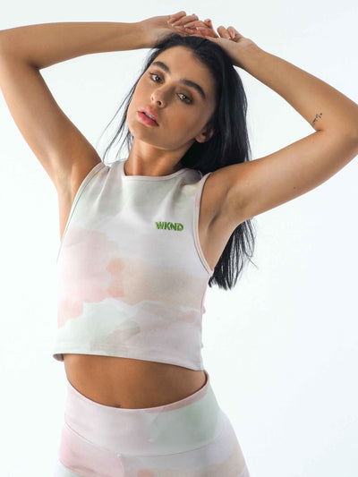 A cropped vest in a watercolour tie dye print. The WKND Apparel logo is embroidered to the chest.