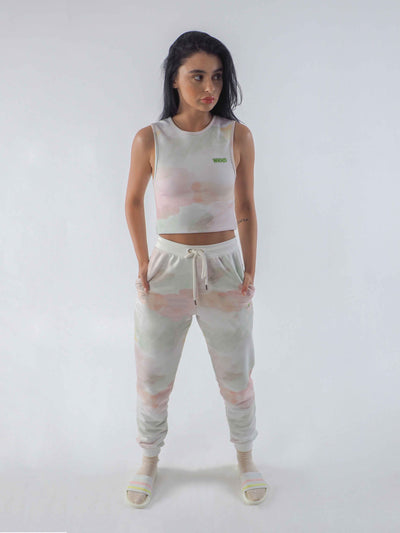 Model wearing joggers in a watercolour tie dye print and matching cropped vest.