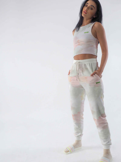 Model wearing joggers in a watercolour tie dye print and matching cropped vest.