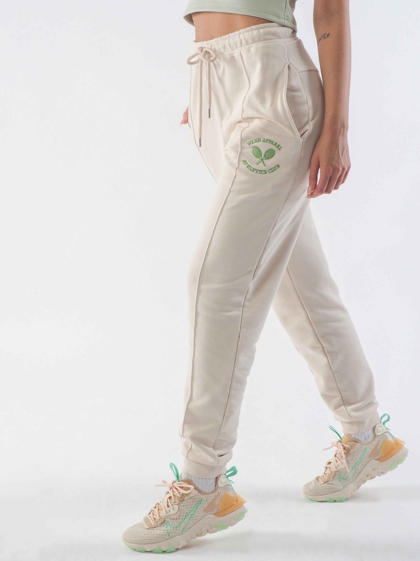 Model is wearing joggers in the colour eggnog.