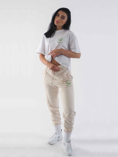 Model is wearing joggers in the colour eggnog and the WKND Apparel white cropped t-shirt..